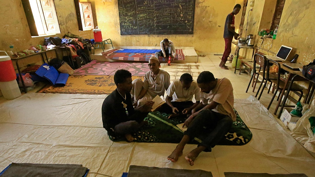 People sit in a classroom at a school that has been transformed into a shelter for people displaced by the conflict in Sudan's northern border town of Wadi Halfa near Egypt, September 11, 2023. /CFP