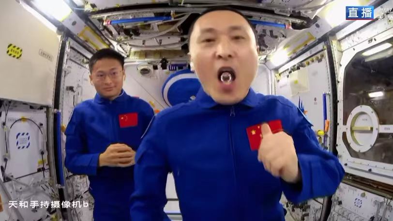 Zhu Yangzhu swallows water after demonstrating how the water surface reacts to being hit with a table tennis ball when livestreaming a science lecture from the space station, September 21, 2023. /CMG