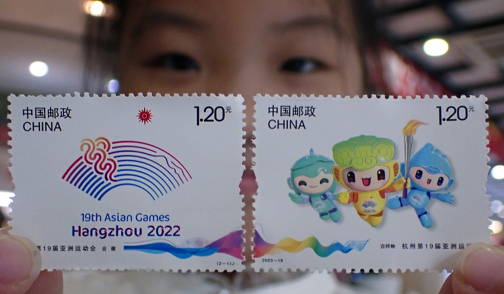 Photo taken on September 23, 2023 shows a citizen holding the newly issued postage stamps of the 19th Asian Games in a post office in Suzhou, Jiangsu Province, China. /CFP