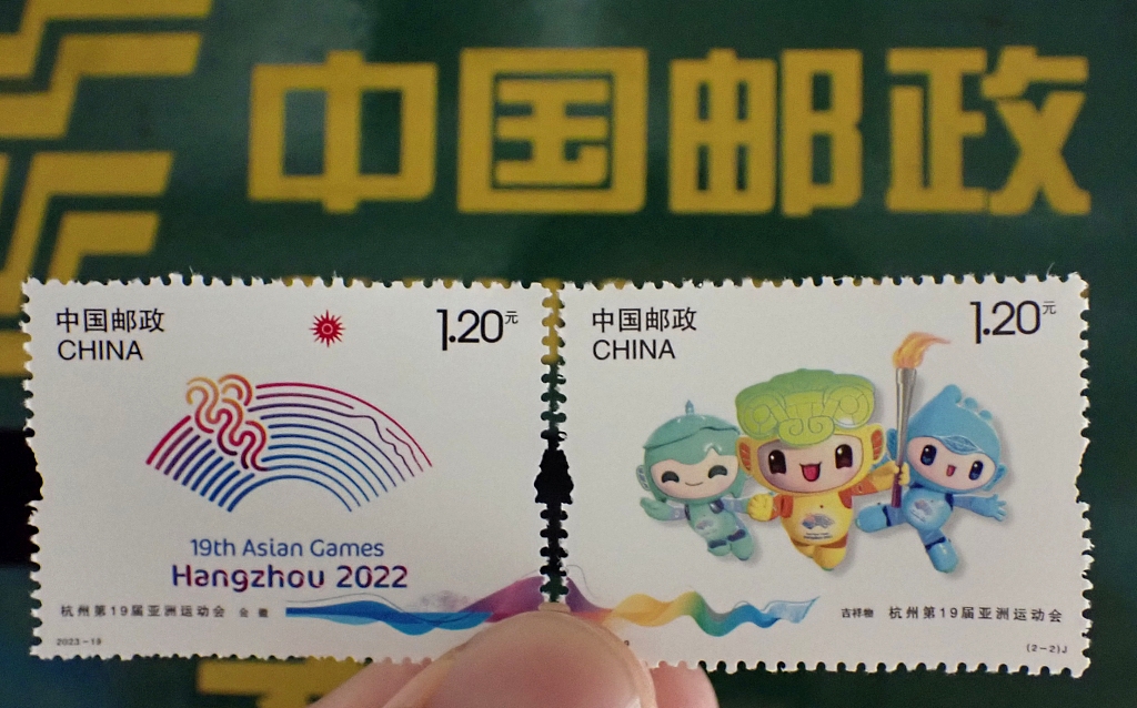 Photo taken on September 23, 2023 shows a citizen holding the newly issued postage stamps of the 19th Asian Games in a post office in Suzhou, Jiangsu Province, China. /CFP