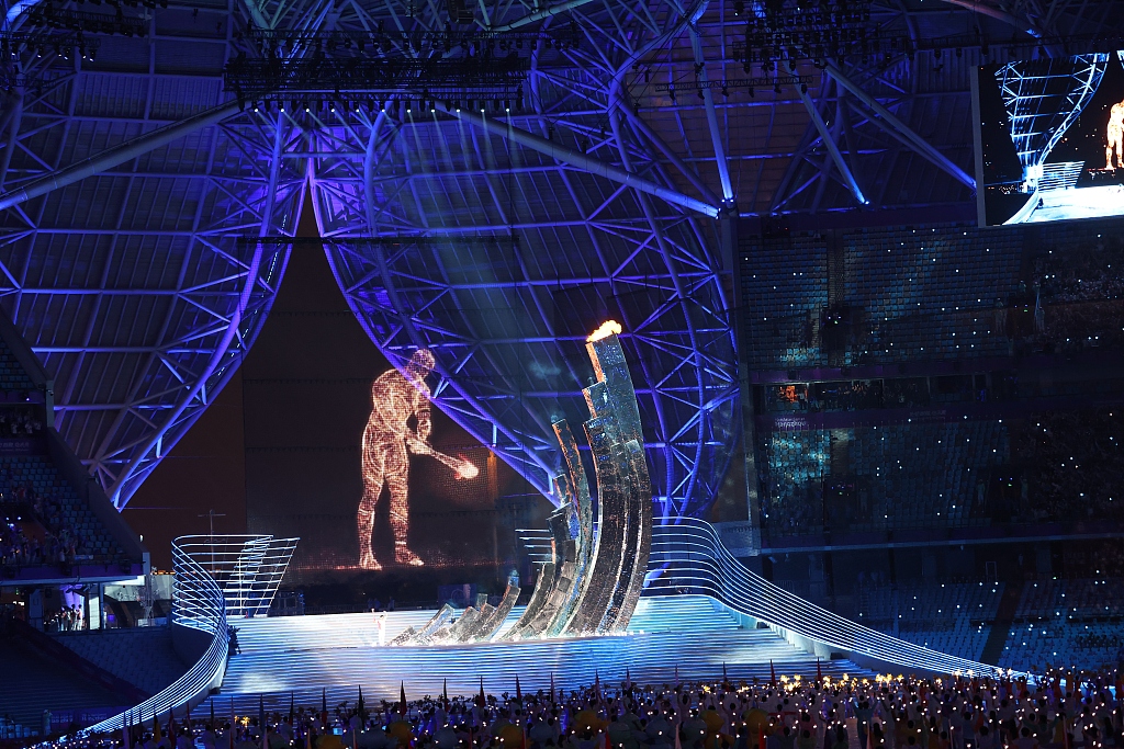 A digital figure and Olympic champion Wang Shun ignite the cauldron together at the opening ceremony of the 19th Asian Games in Hangzhou, China, September 23, 2023. /CFP  