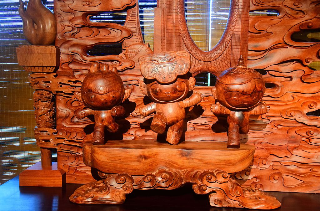 A picture taken on August 18, 2023 shows the mascots of the 19th Asian Games Chenchen, Congcong and Lianlian depicted in a wood carving in Hangzhou, Zhejiang. /CFP