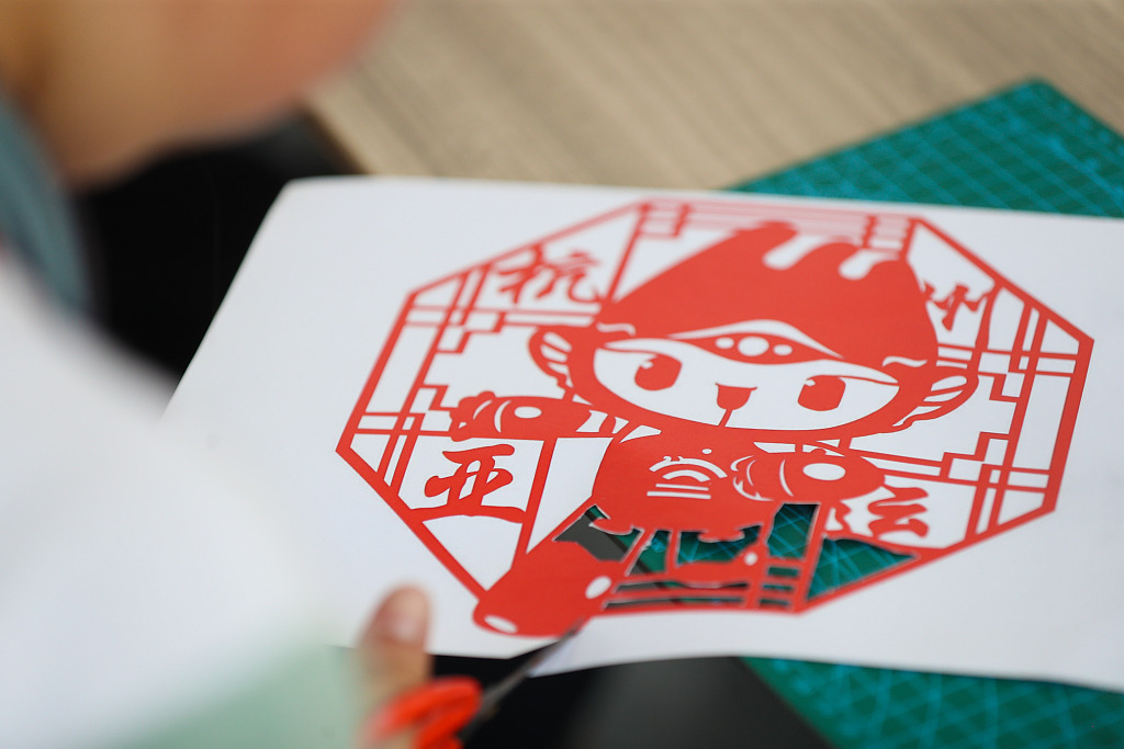 A picture taken on June 9, 2023 shows 19th Asian Games mascot Chenchen depicted in a paper-cutting artwork in Deqing County, Huzhou, Zhejiang. /CFP
