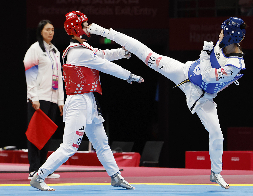 Zhou Zeqi (R) of China fights in the taekwondo mixed team event during the 19th Asian Games in Hangzhou, China, September 25, 2023. /CFP