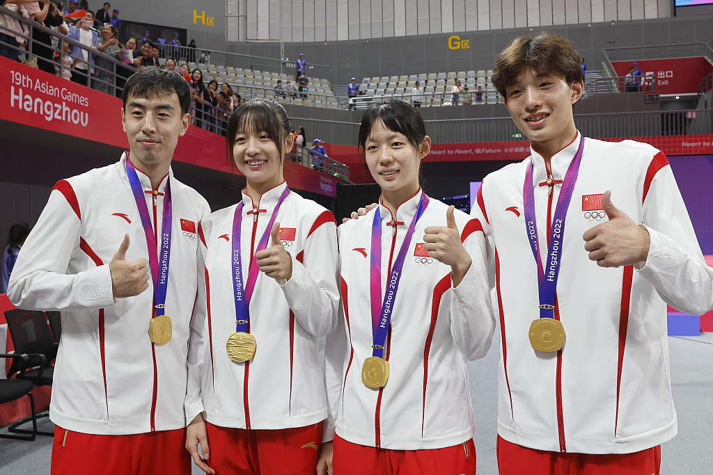 L-R: China's Song Zhaoxiang, Zhou Zeqi, Song Jie and Cui Yang celebrate after winning the gold medal in the taekwondo mixed team event during the 19th Asian Games in Hangzhou, China, September 25, 2023. /CFP