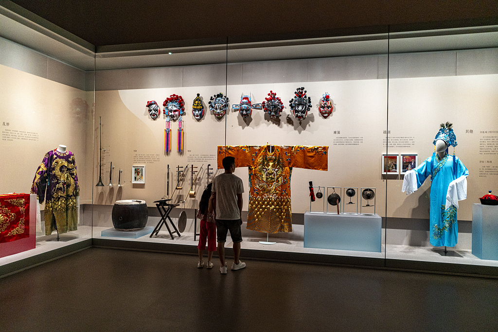 Opera clothing and facial masks are on display at the Zhejiang Intangible Cultural Heritage Museum in Hangzhou, Zhejiang Province. /CFP