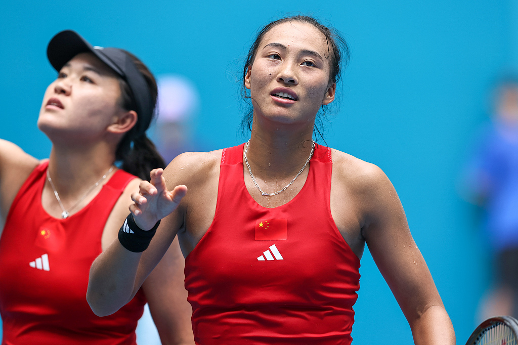 Zhu Lin (L) and Zheng Qinwen gesture to the audience after the Hangzhou Asian Games tennis women's singles final in Hangzhou, China, September 29, 2023. /CFP