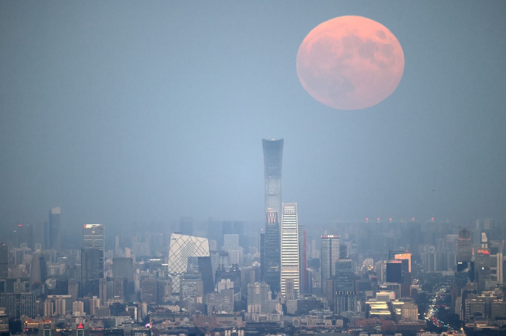 A photo taken on September 29, 2023, shows the full moon shining above the central business district area of Beijing. /IC