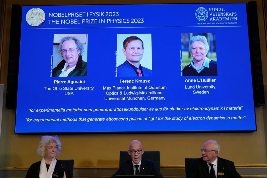 Hans Ellegren (C), permanent secretary of the Royal Academy of Sciences, flanked by Eva Olsson (L) and Mats Larsson, members, announces this year's Nobel Prize winners in Physics, at the Royal Academy of Sciences in Stockholm, Sweden, October 3, 2023.