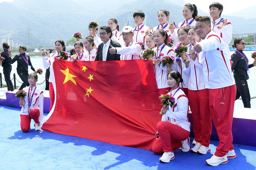 Chinese athletes celebrate on the podium after winning the dragon boat women's 200m straight race event in the 19th Asian Games in Hangzhou, Zhejiang Province, China, October 4, 2023. /CFP