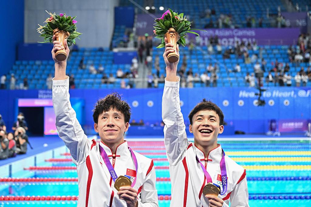 China's He Chao (L) and Yan Siyu celebrate after winning the men's synchronized 3m springboard diving final during the 19th Asian Games in Hangzhou, China, September 30, 2023. /CFP