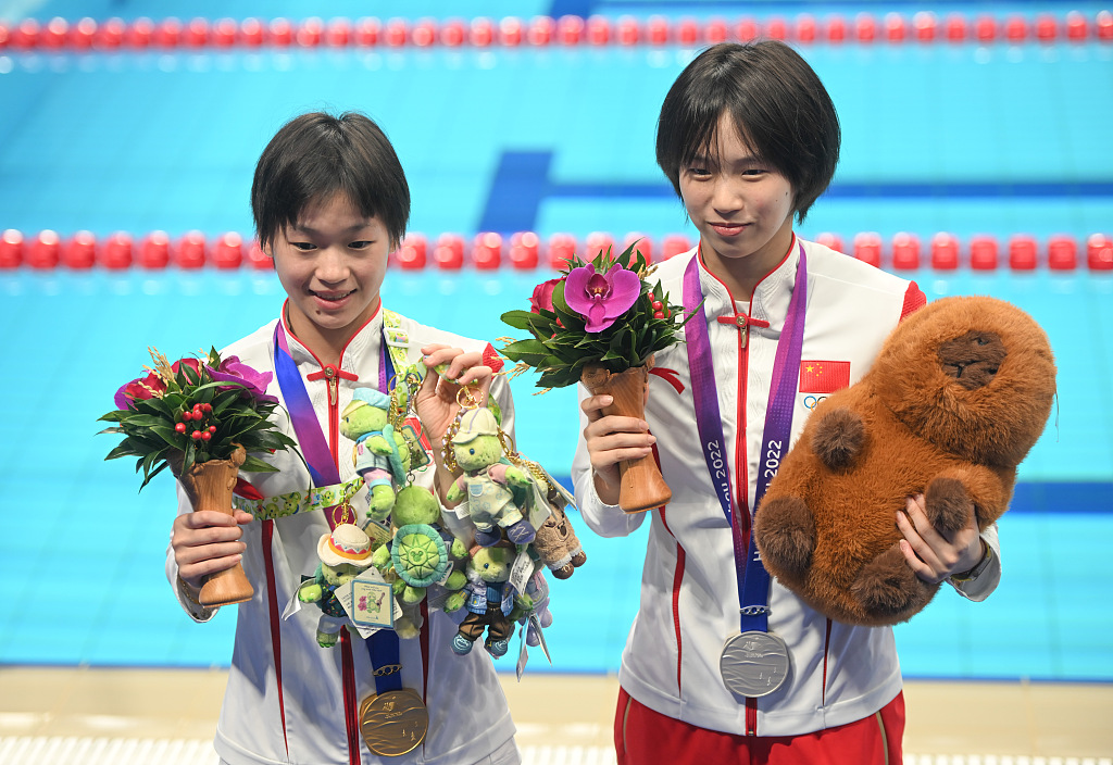 China's Quan Hongchan (L) and Chen Yuxi celebrate after winning the gold and silver medals in the women's 10m platform diving final during the 19th Asian Games in Hangzhou, China, October 3, 2023. /CFP 