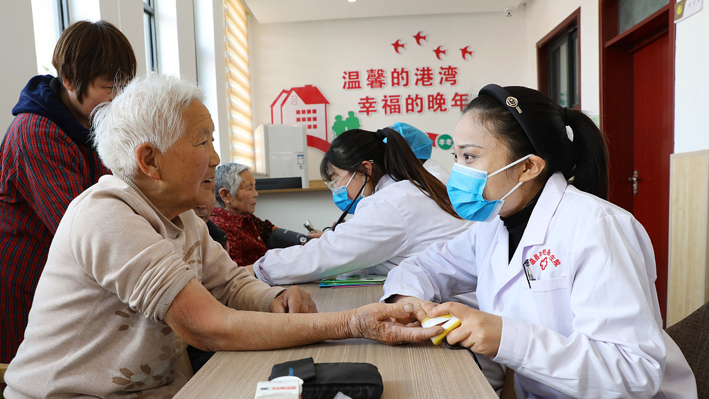 Medical workers carry out free medical consultations for the elderly people at an elderly care service center in Jiaozuo City, central China's Henan Province, April 7, 2023. /CFP