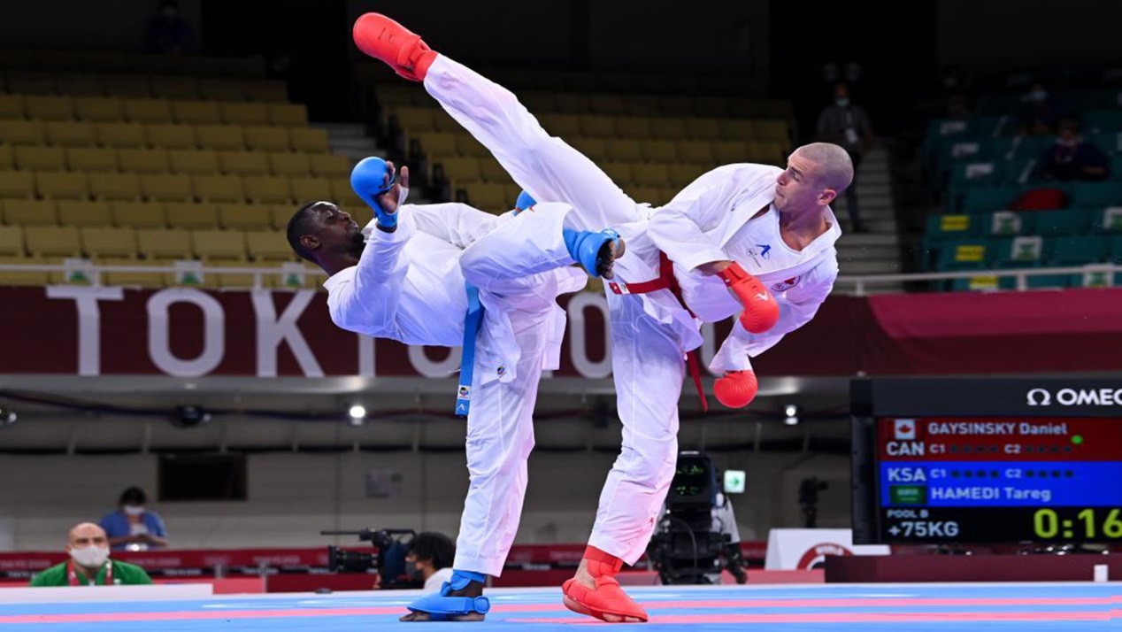 Daniel Gaysinsky of Canada (R) and Sajad Ganjzadeh (L) of Iran compete during the men's kumite +75kg elimination round of karate at Tokyo 2020 Olympic Games in Tokyo, Japan, August 7, 2021. /Xinhua