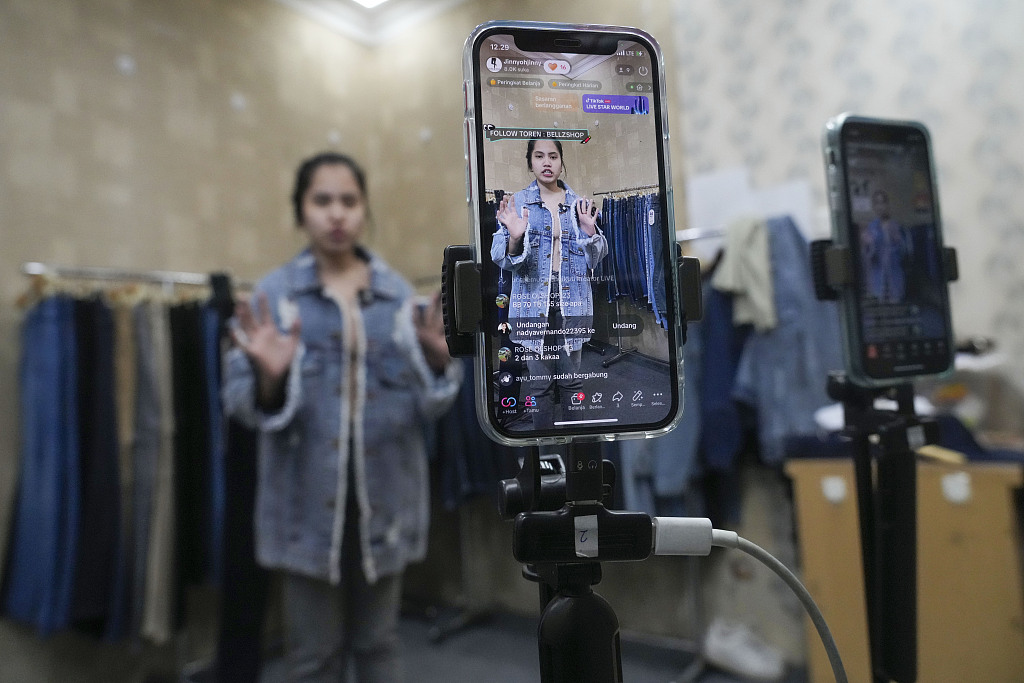 A seller offers merchandise using live streaming at a store in the Tanah Abang textile market in Jakarta, Indonesia. Oct. 4, 2023. /CFP