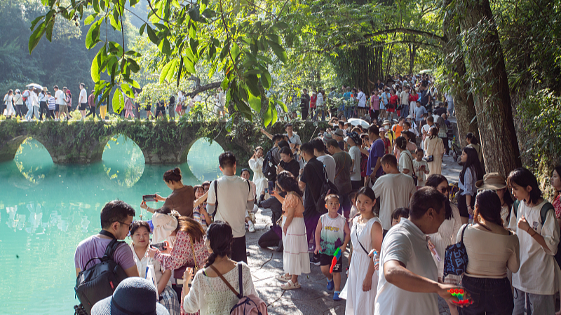 Tourists visit Xiaoqikong scenic area in Libo County, southwest China's Guizhou Province, October 3, 2023. /CFP