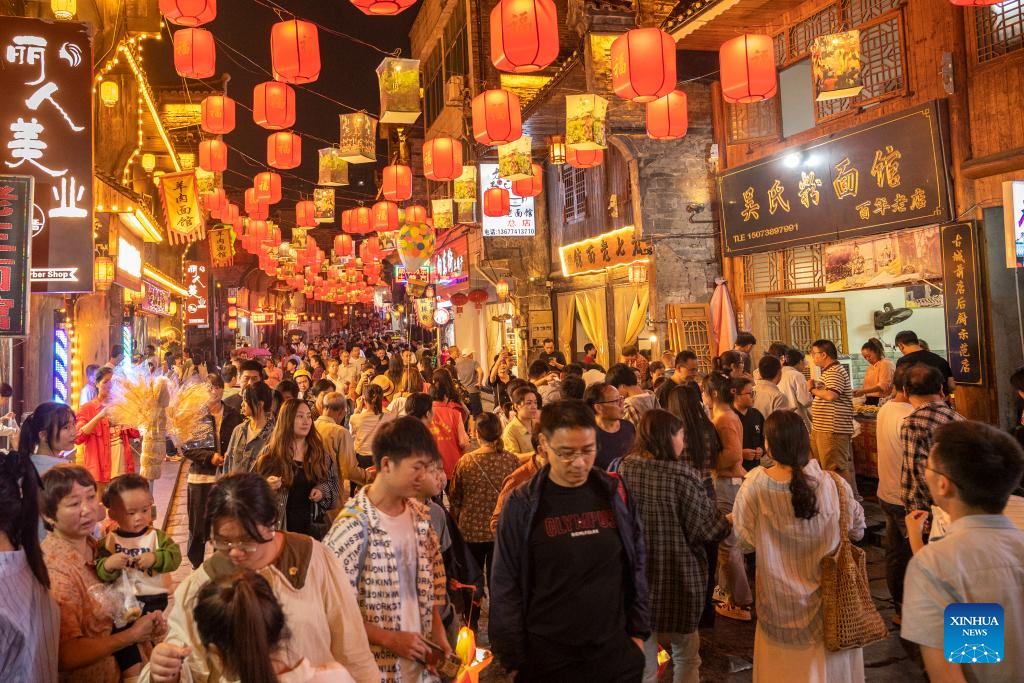 Tourists visit Xiangdong Street of Xinhua County, central China's Hunan Province, October 2, 2023. /Xinhua