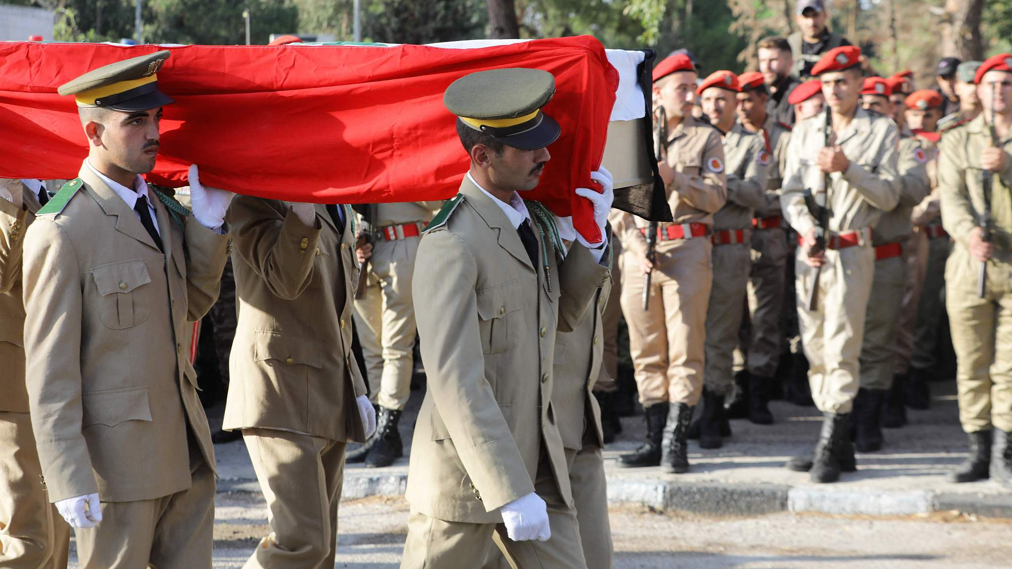 Syrian soldiers carry a casket during the funeral of victims of a drone attack targeting a Syrian military academy, outside a hospital in government-controlled Homs on October 6, 2023. /CFP