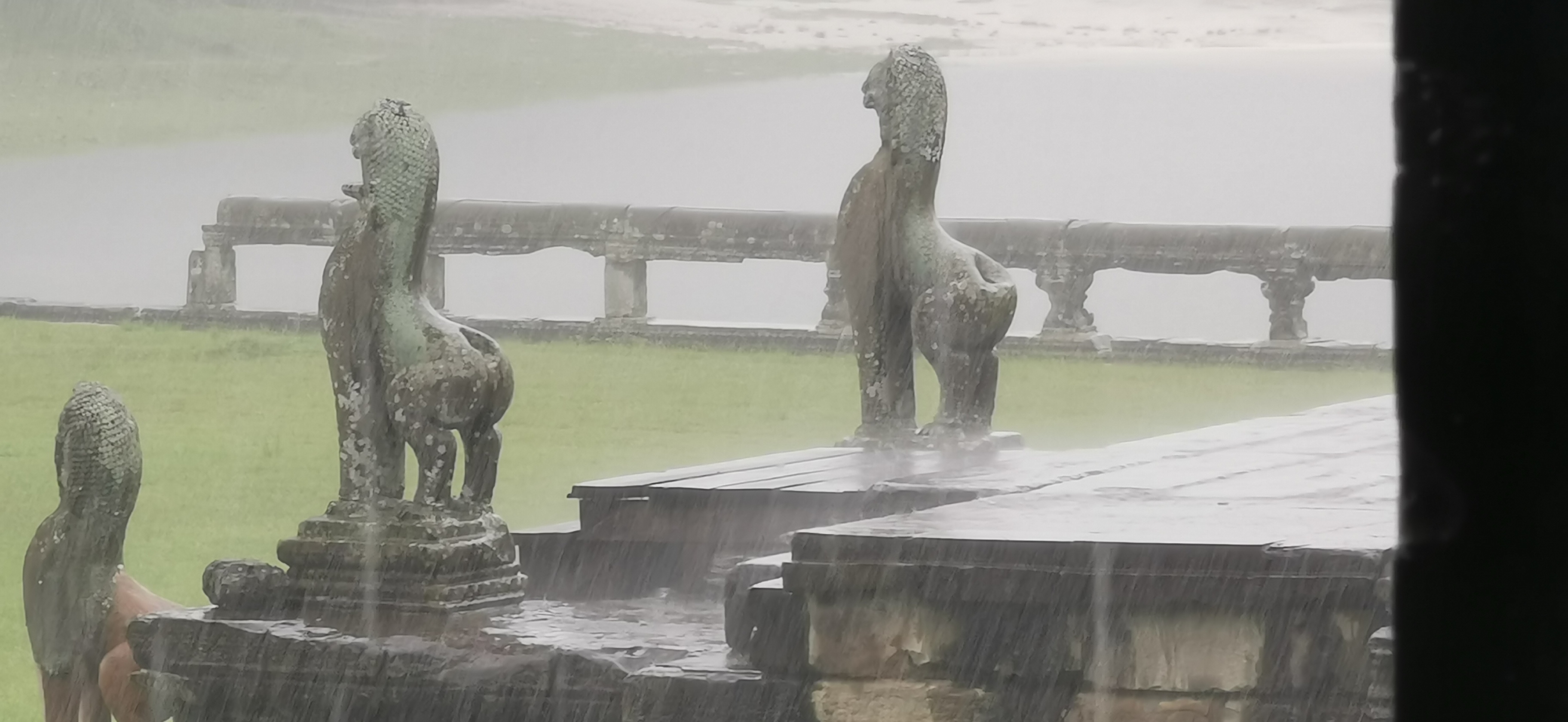 Rain falls on the sculptures at Angkor Archaeological Park in Siem Reap, Cambodia. /CGTN