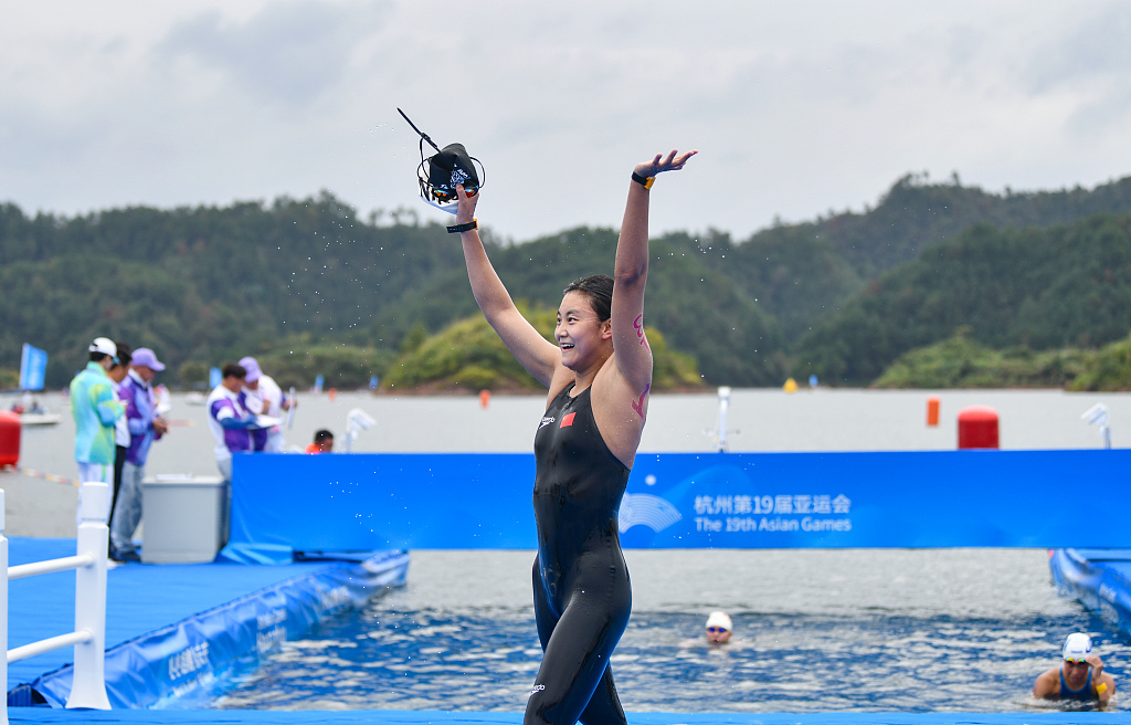 Wu Shutong of China celebrates after winning the women's marathon swimming event during the 19th Asian Games in Jieshou Township, China, October 6, 2023. /CFP