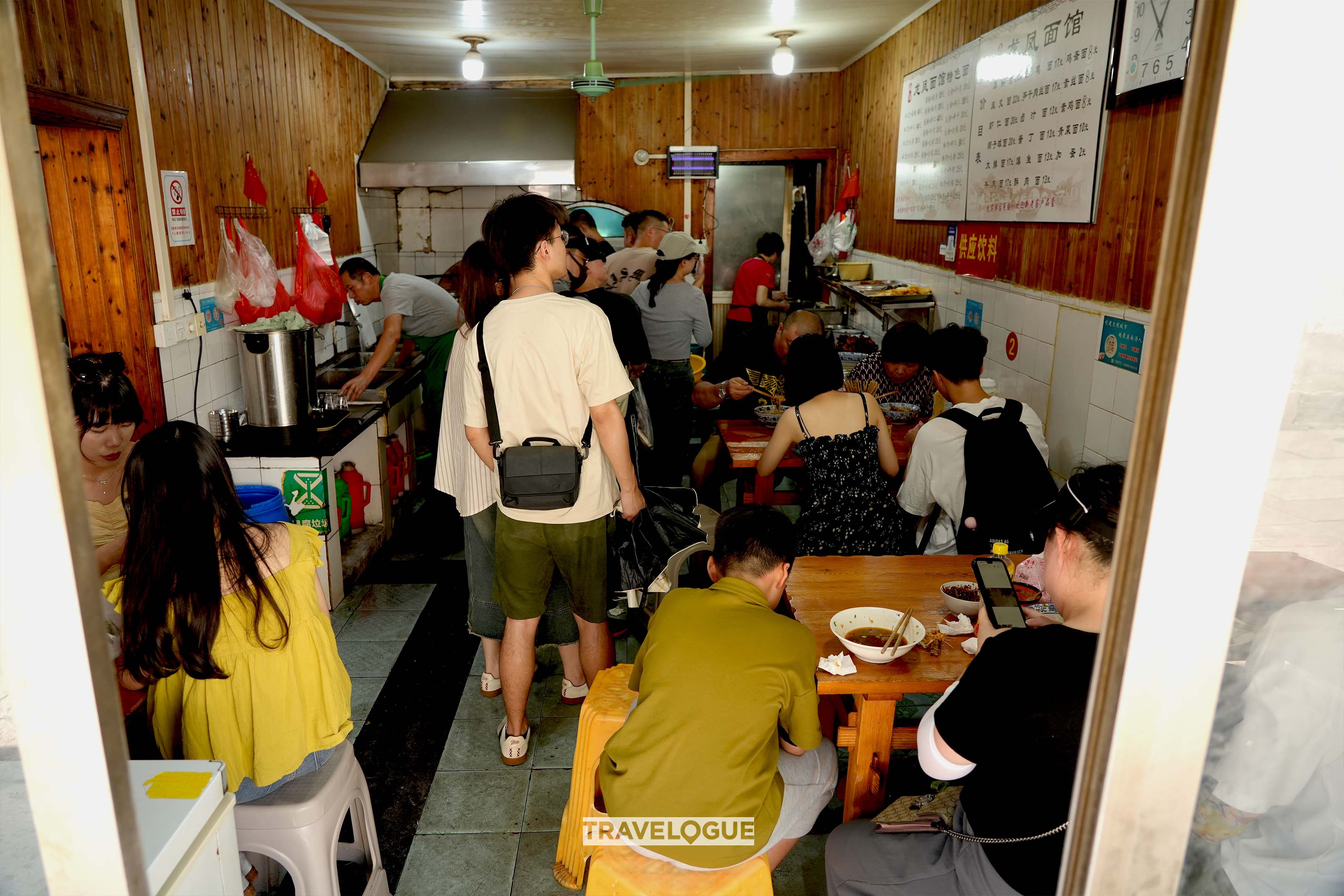 Tourists and locals dine at a noodle restaurant in Nanxun ancient town in Huzhou, Zhejiang Province. /CGTN 