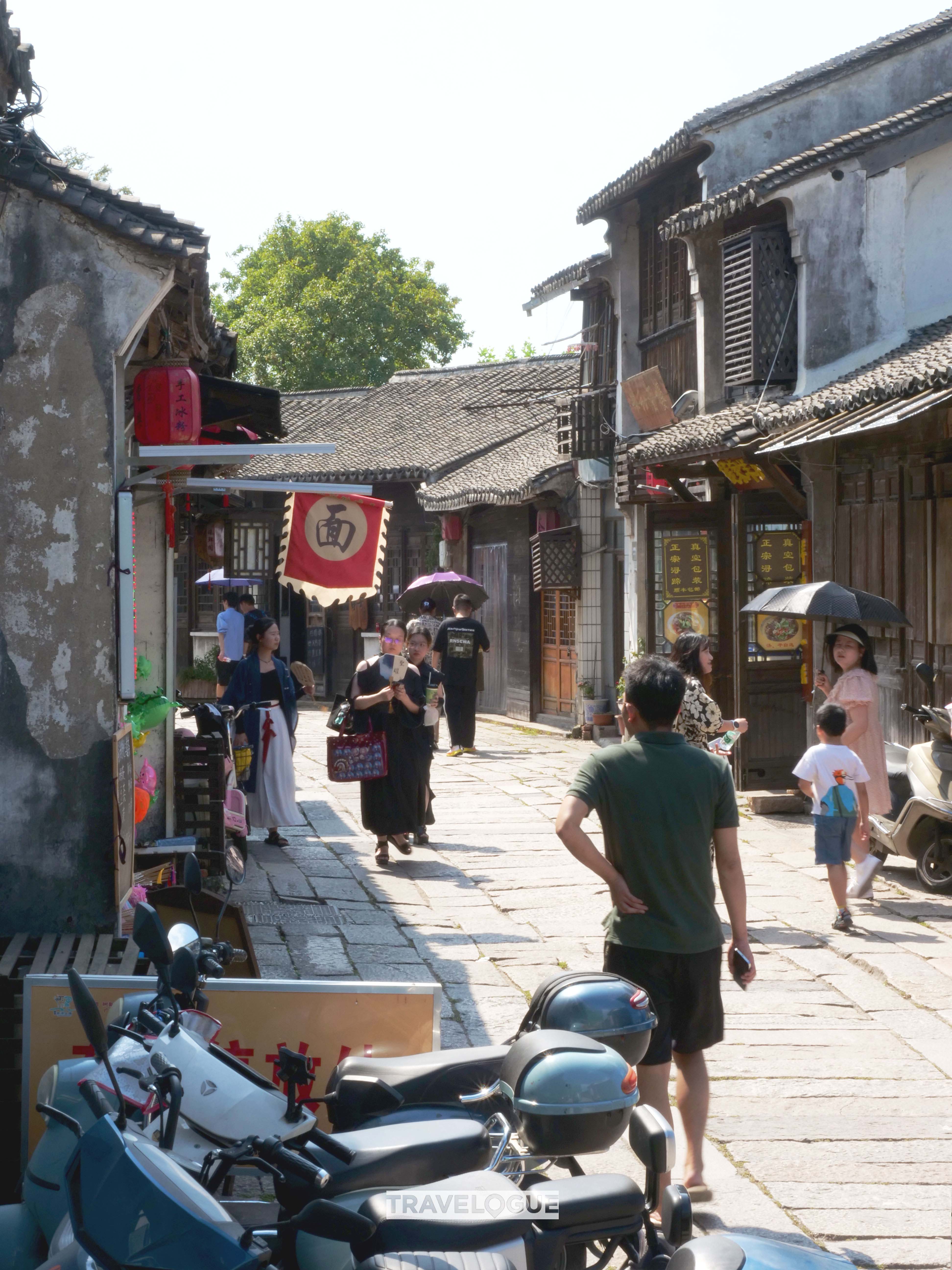 Tourists stroll along the cobbled streets of Nanxun ancient town in Huzhou, Zhejiang Province. /CGTN 