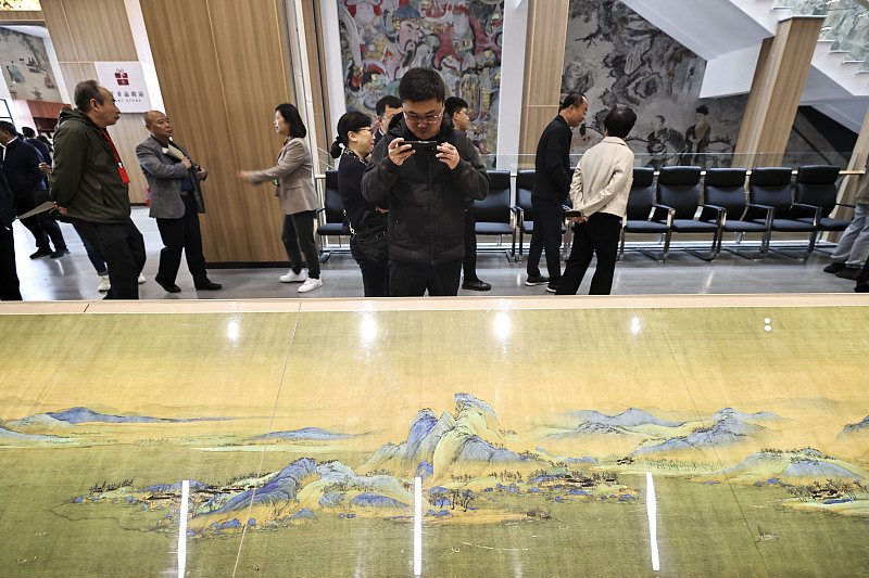 A visitor takes photos at the Jinzhiyuan Mural Museum in Jinzhong City, Shanxi Province, October 8, 2023. /CFP