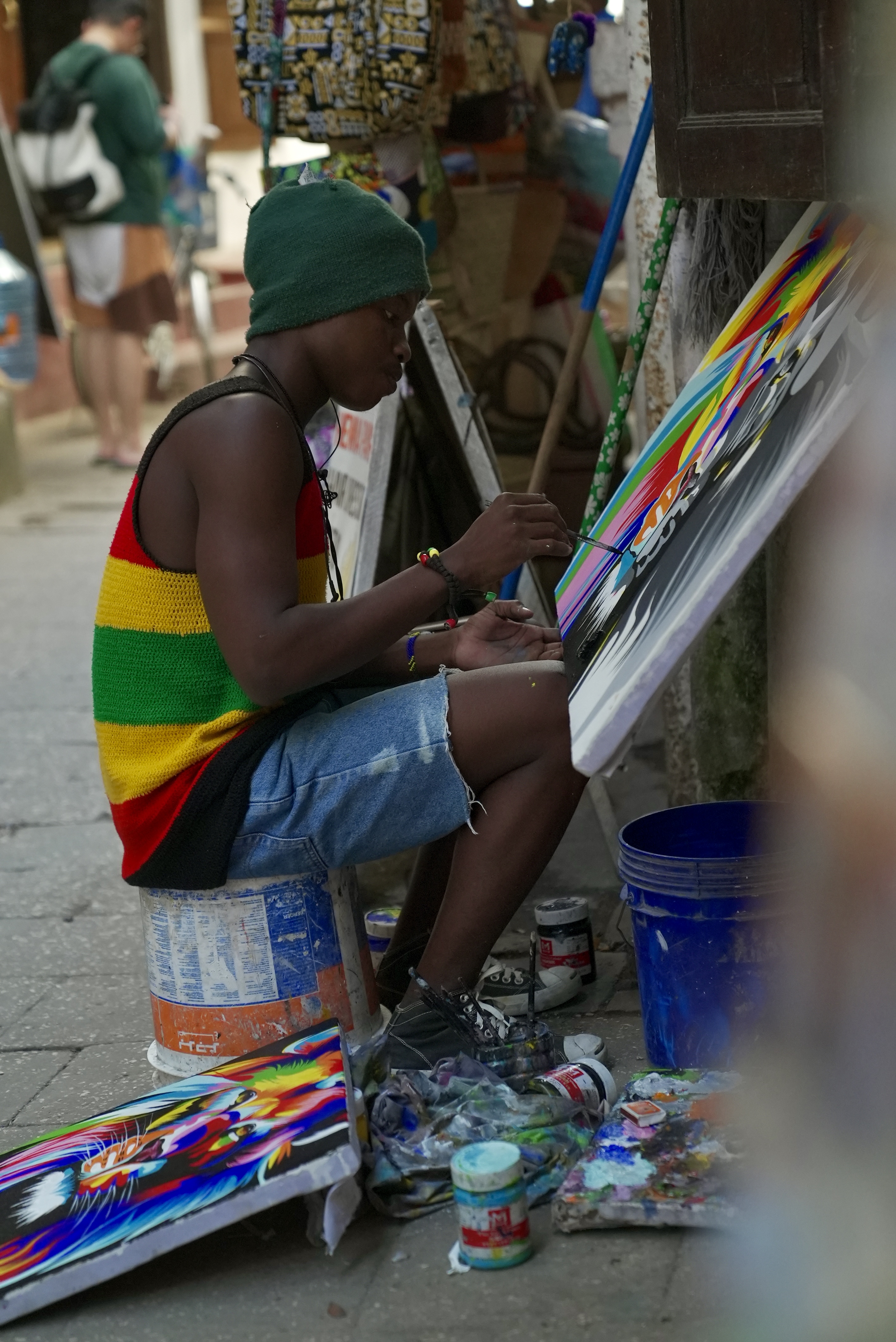 An artist works on a painting on a street in Zanzibar Island in Tanzania. /CGTN