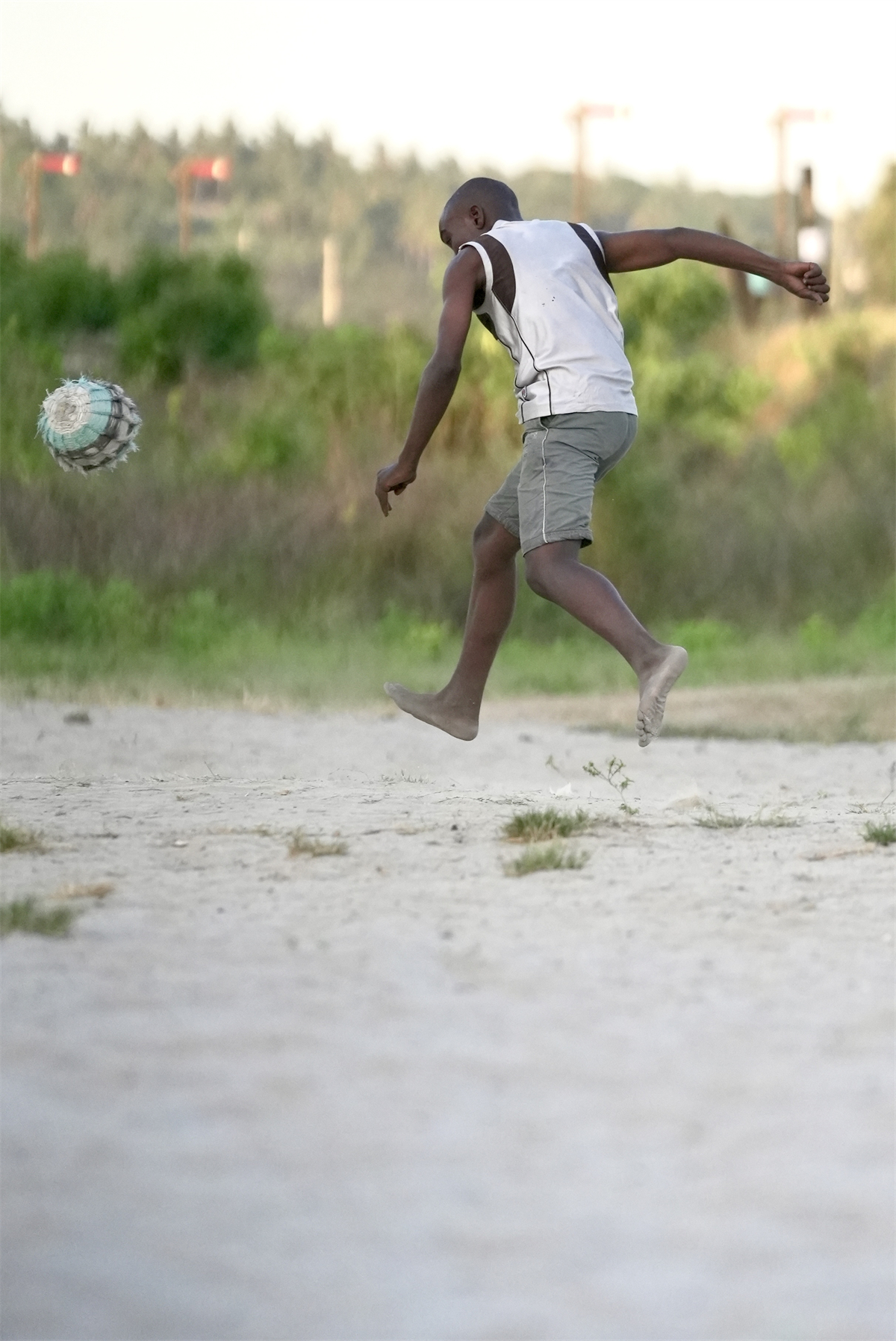 A barefooted youngster enjoys a game of football despite the lack of a proper playing field or ball at a small village in Tanzania. /CGTN