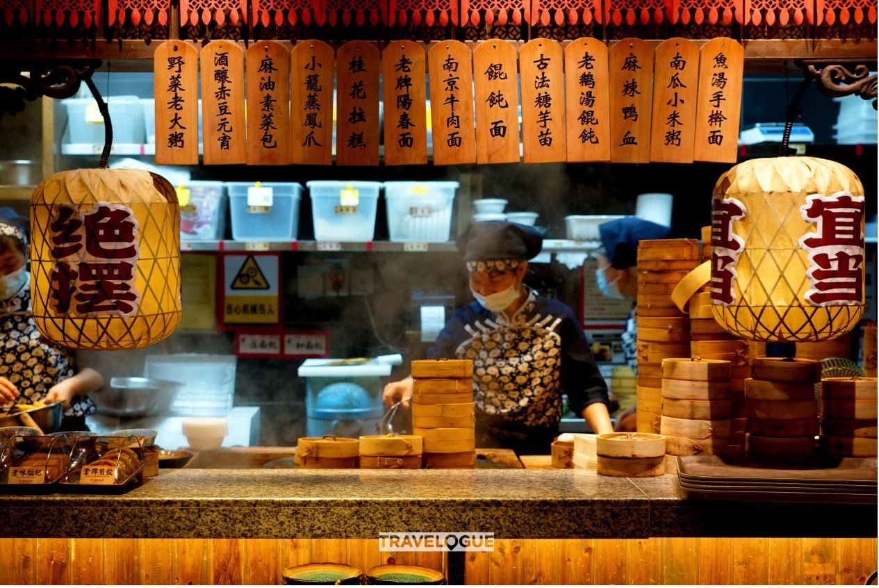 Chefs cook at a restaurant in Nanjing, China. /CGTN