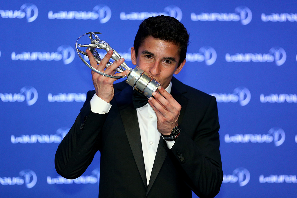 Marc Marquez kisses his trophy after winning the Laureus World Breakthrough of the Year award during the 2014 Laureus World Sports Awards Ceremony in Kuala Lumpur, Malaysia, March 26, 2014. /CFP