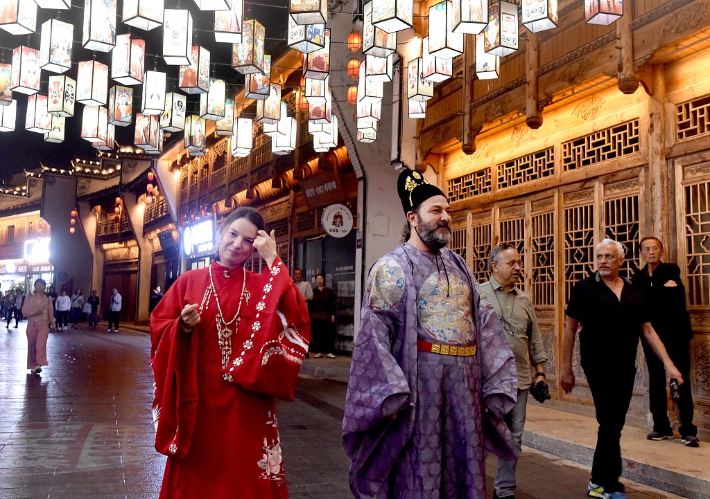 Arabic artists dressed in Jiangxi Opera costumes walk on Laobeijie Cultural Street on October 10, 2023 during their visit to Leping City, Jiangxi Province. /CFP