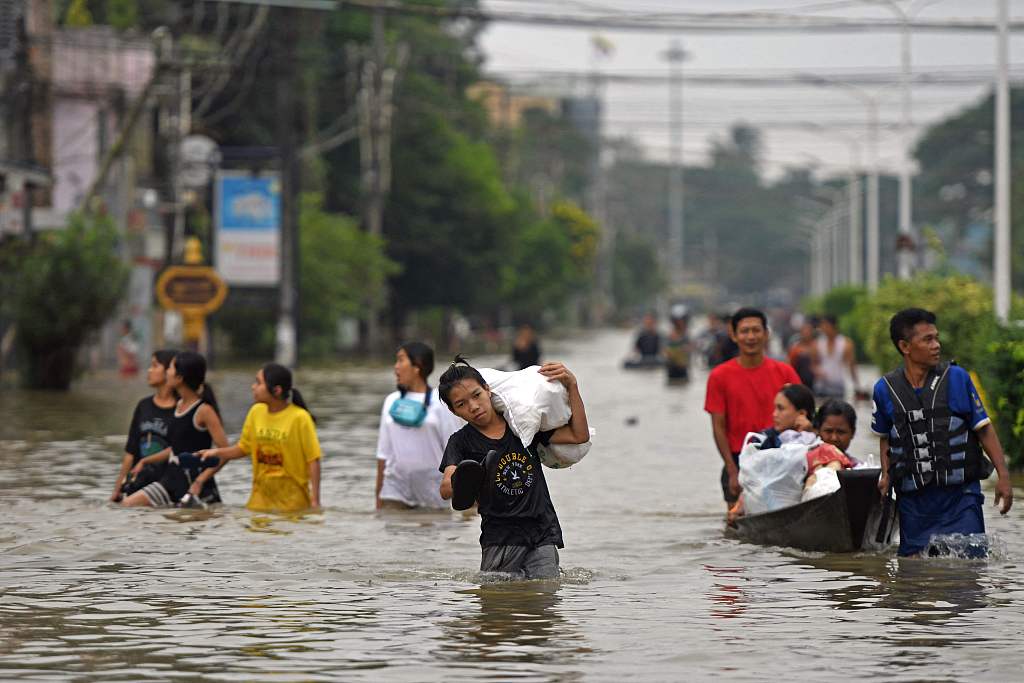 Residents walk through flooded streets in Bago region of Myanmar. October 9, 2023. /CFP