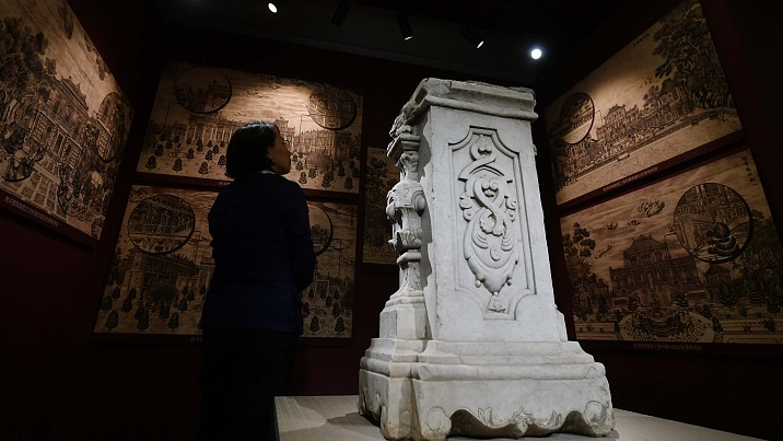 A visitor looks at one of the seven pillars looted by foreign troops from the Old Summer Palace in Beijing, October 13, 2023. /CFP