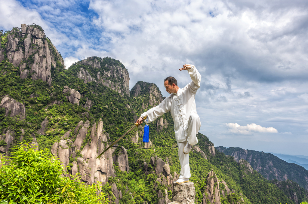 A man practices Tai Chi with a sword on Sanqing Mountain in Shangrao City, Jiangxi Province. /File Photo: CFP