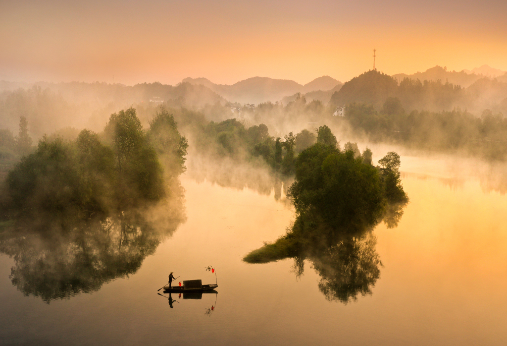 An aerial view of a boat floating on the mirror-like waters of Wuyuan County, Shangrao City, Jiangxi Province. /File Photo: CFP