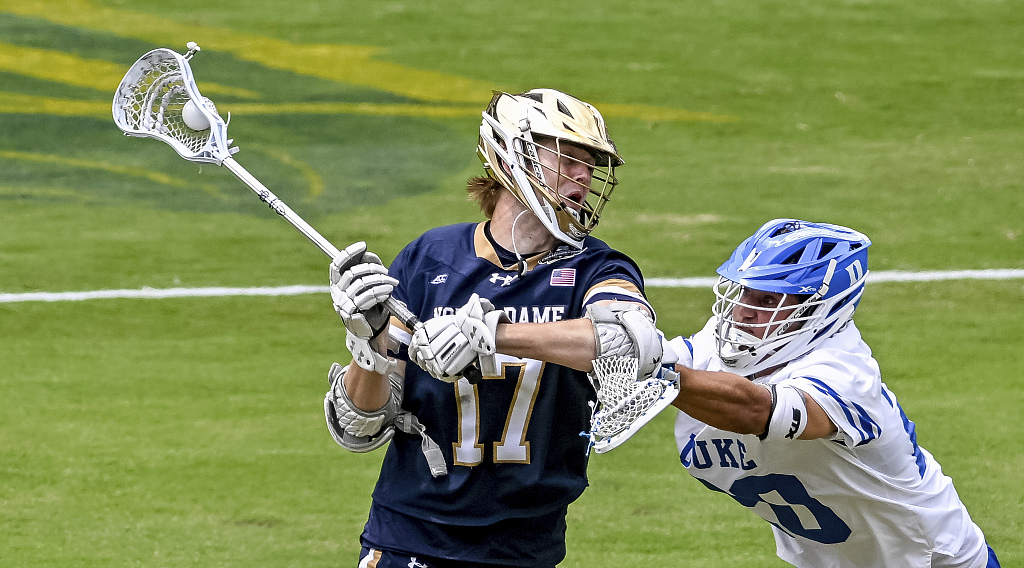 Reilly Gray (L) of Notre Dame University takes a shot on goal in the NCAA Division I Men's Lacrosse Championship game against Duke University at Lincoln Financial Field in Philadelphia, Pennsylvania, May 29, 2023. /CFP