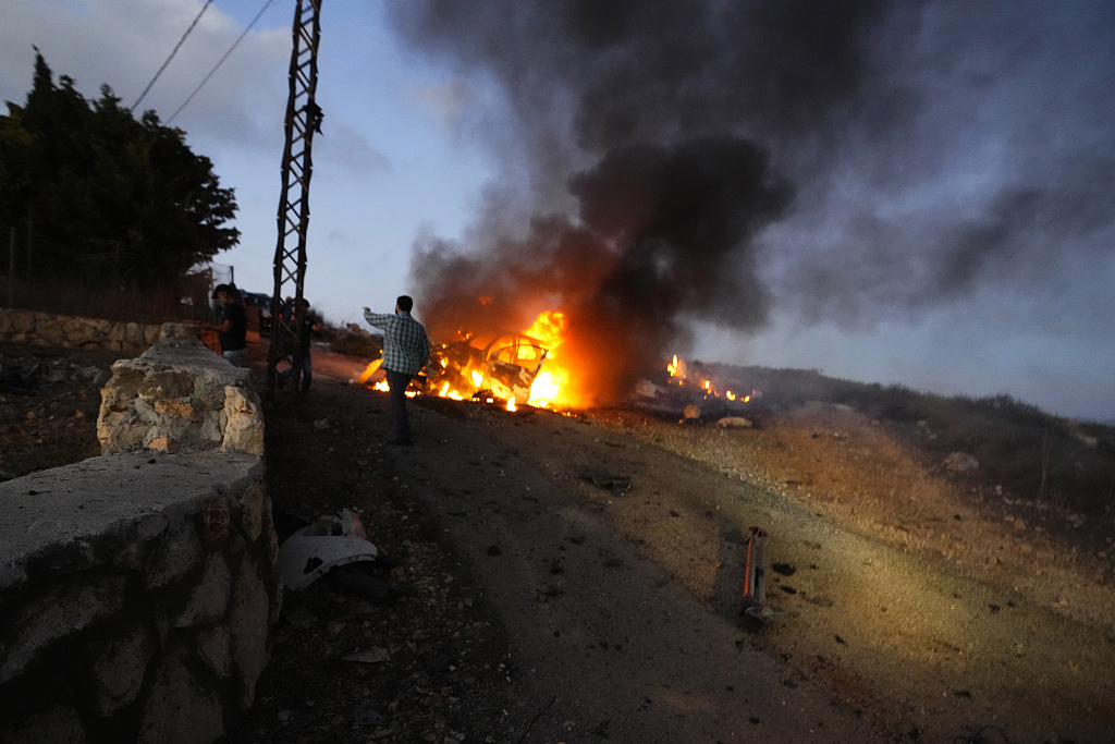 A journalist's car burns after it was hit by Israeli shelling in the Alma al-Shaab border village with Israel, south Lebanon, October 13, 2023. /CFP