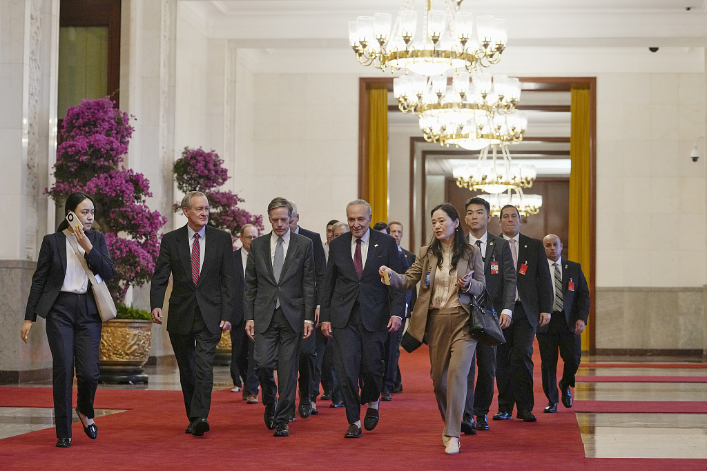 U.S. Senate Majority Leader Chuck Schumer walks through a hallway with his members of the delegation as they head for a bilateral meeting with Chinese President Xi Jinping at the Great Hall of the People in Beijing, capital of China, October 9, 2023. /CFP