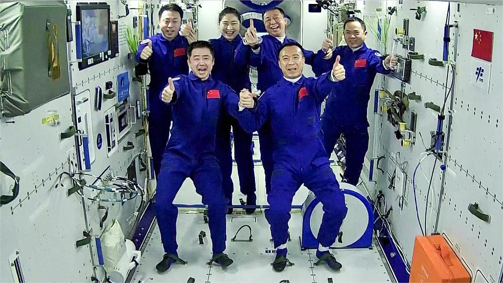 The Shenzhou-15 and Shenzhou-14 crews take a group photo with their thumbs up after a historic gathering in space, November 30, 2022. /CFP