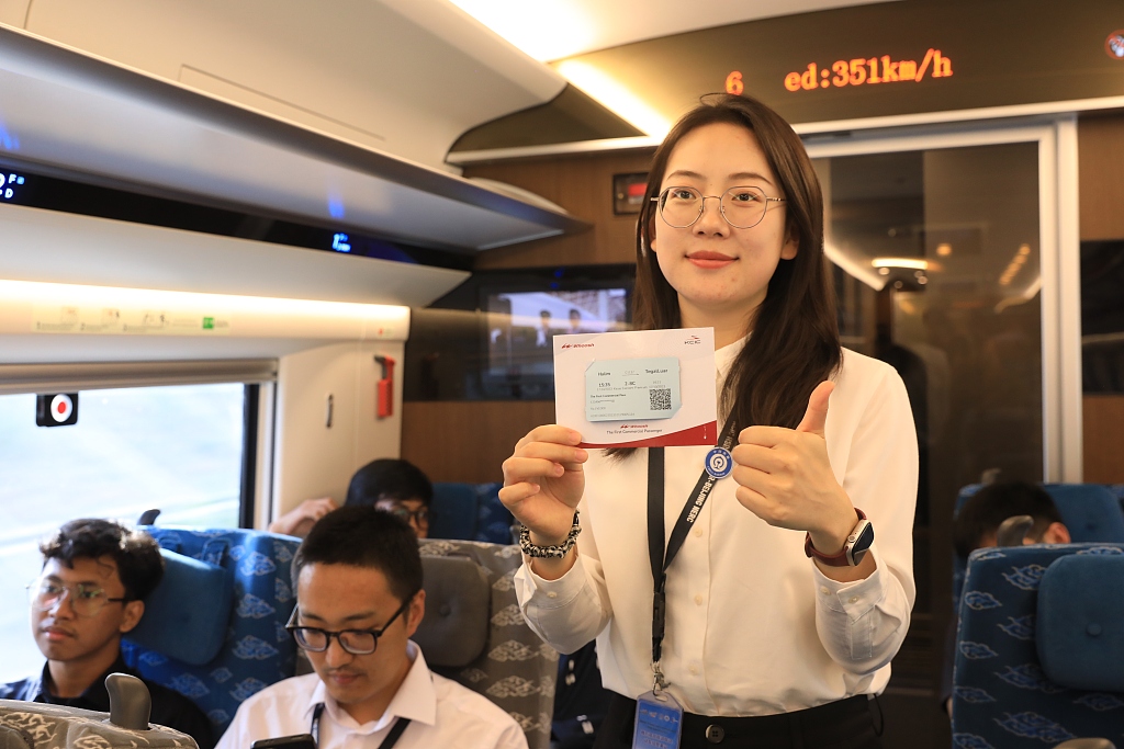 A passenger shows the train ticket of the Jakarta-Bandung HSR, with speedometer indicating that the train is operating at a speed of 351 km/h, October 17, 2023. /CFP