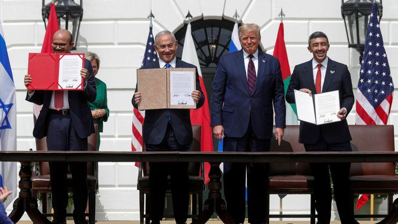 Bahrain's Foreign Minister Abdullatif Al Zayani, Israel's Prime Minister Benjamin Netanyahu and the United Arab Emirates' Foreign Minister Abdullah bin Zayed display their copies of signed agreements while U.S. President Donald Trump looks on as they participate in the signing ceremony of the Abraham Accords, normalizing relations between Israel and some of its Middle East neighbors in a strategic realignment of Middle Eastern countries against Iran, on the South Lawn of the White House in Washington, U.S., September 15, 2020. /Reuters