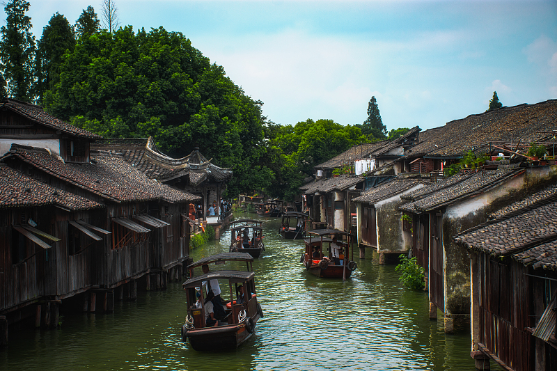 Boats drift along a waterway in the ancient town of Wuzhen in Zhejiang Province. /CFP