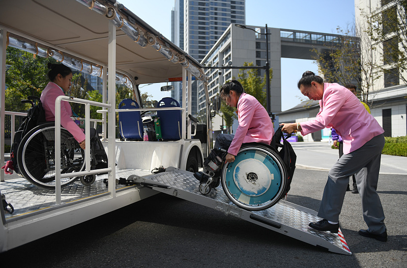 Workers set up customized shuttle buses at the Asian Paralympic Games Village in Hangzhou, Zhejiang Province, October 16, 2023. /CFP