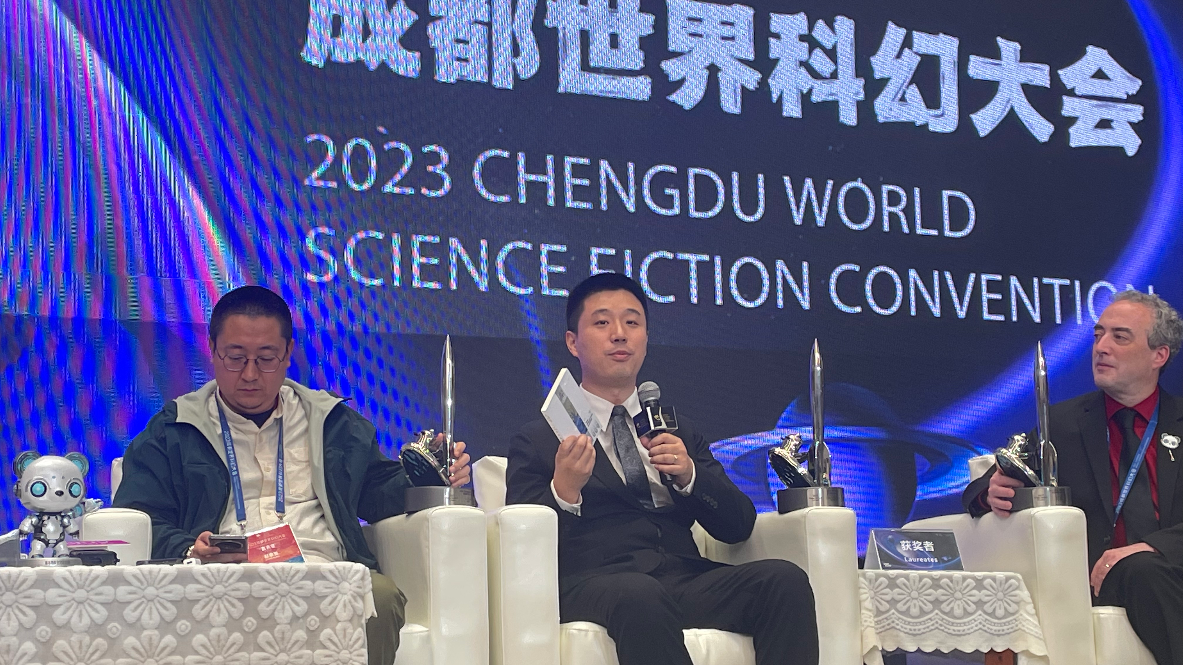 Chinese sci-fi writer Hai Ya (center) holds his award-winning book, 