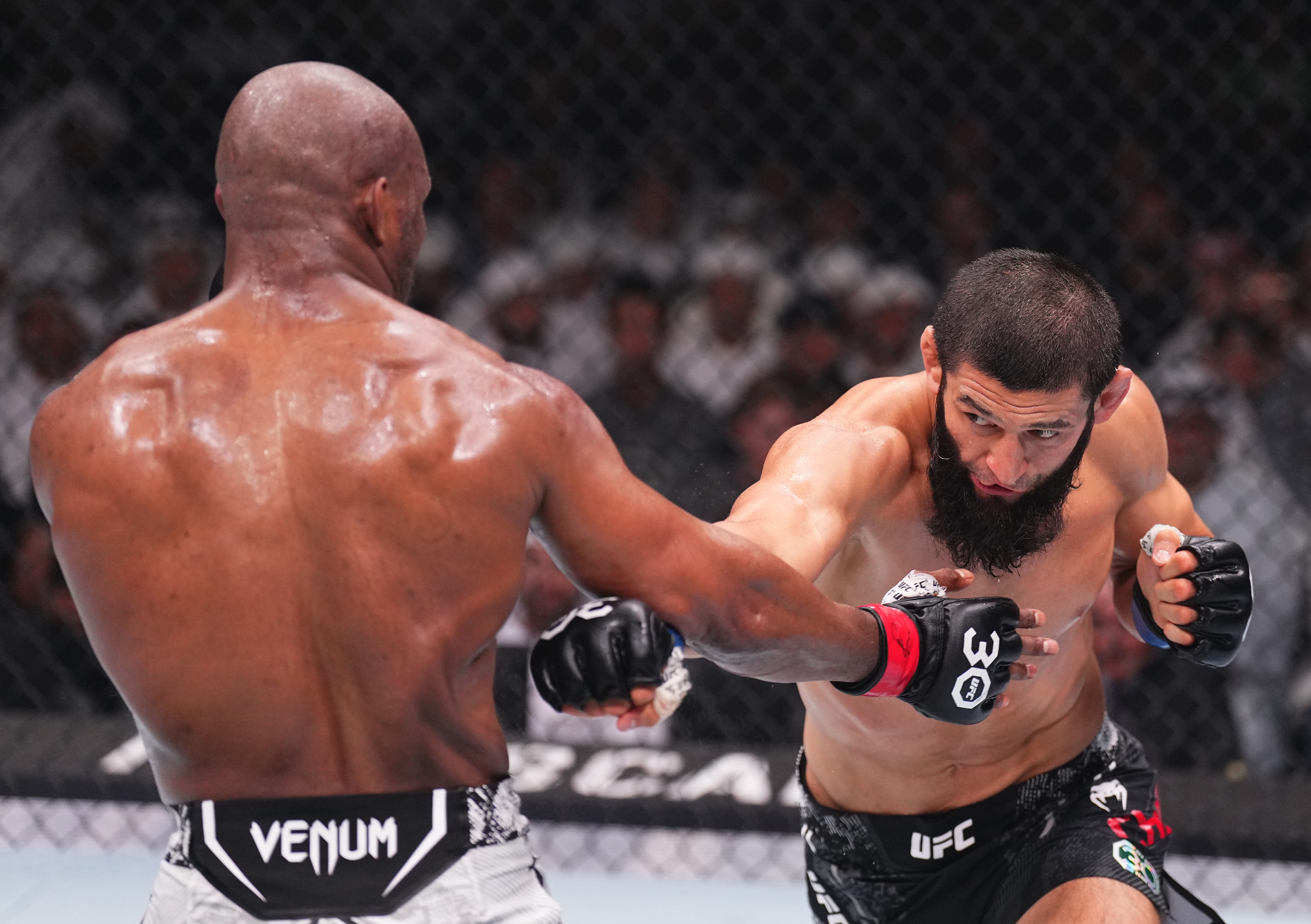 Khamzat Chimaev (R) of Sweden punches Kamaru Usman of the U.S. at UFC 294 at Etihad Arena in Abu Dhabi, the United Arab Emirates, October 21, 2023. /CFP
