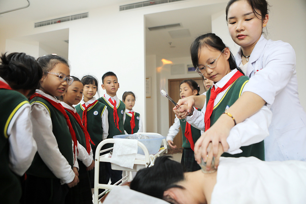 Students take part in a demonstration of cupping therapy, a traditional Chinese method of healthcare, at a hospital in southwest China's Chongqing Municipality, October 18, 2023. /CFP