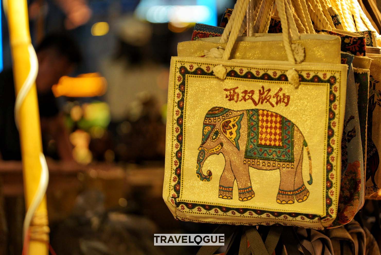 Handbags decorated with local embroidery are on sale at the Star Night Market in Xishuangbanna, Yunnan Province. /CGTN