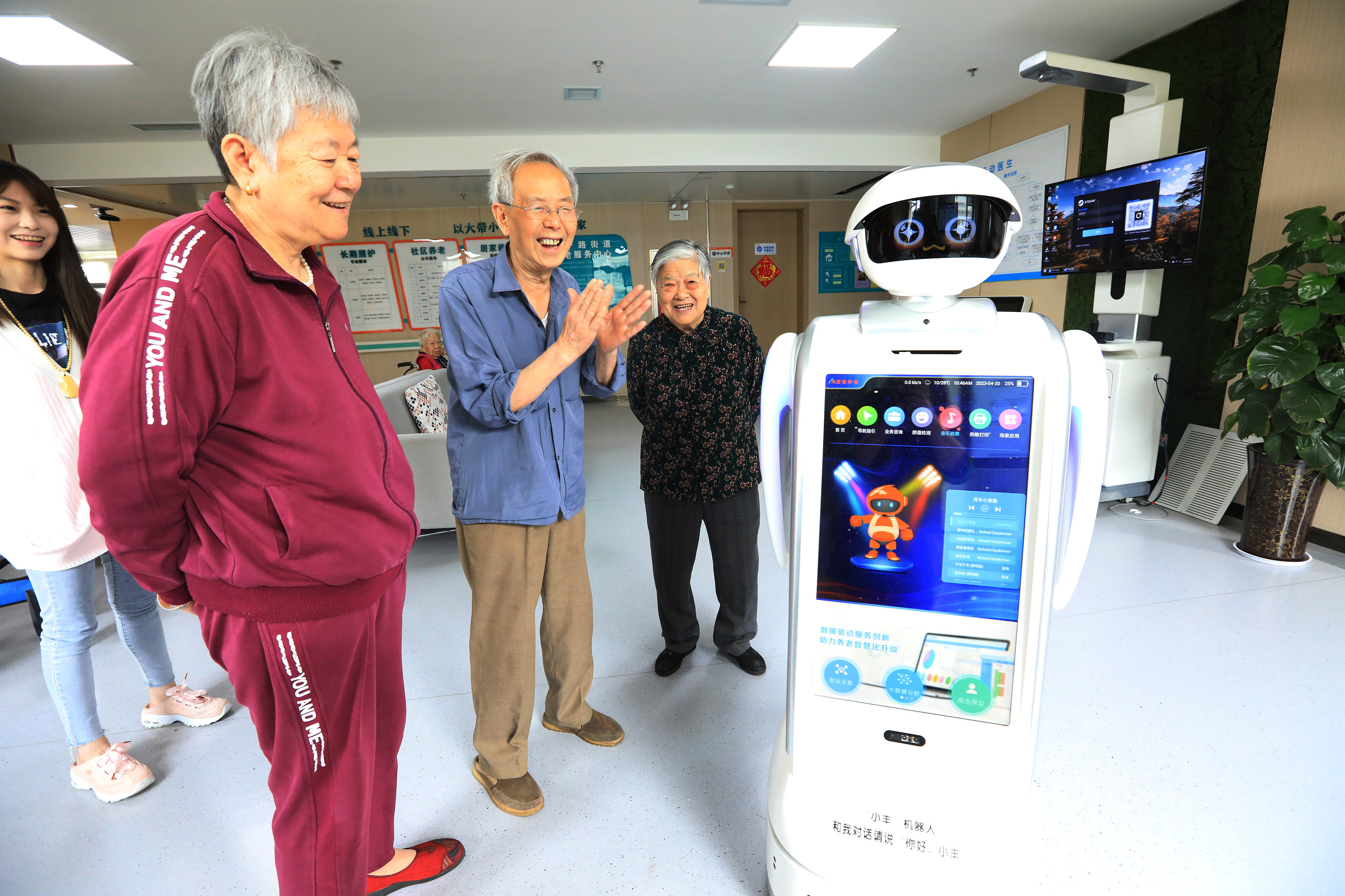 Senior citizens interact with a robot at an elderly care center in Jinshui District, Zhengzhou, central China's Henan Province, April 20, 2023. /CFP