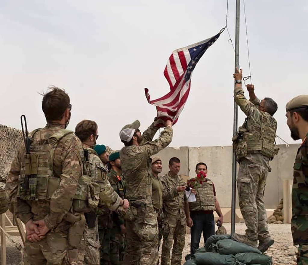 A U.S. flag is lowered as American and Afghan soldiers attend a handover ceremony from the U.S. Army to the Afghan National Army in Helmand Province, Afghanistan, May 2, 2021. /CFP